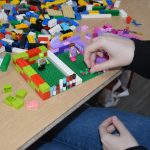 Image of a person building a model using LEGO bricks
